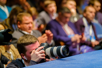 Professional photographer works at business conference