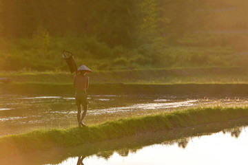 Asian children have fun outdoors with water splashes.