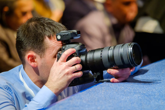 Professional photographer works at business conference