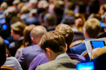 People attend business conference in the congress hall
