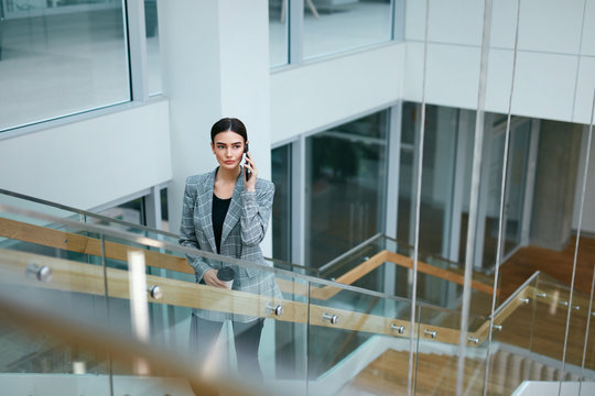 Business Woman Talking On Mobile Phone In Office