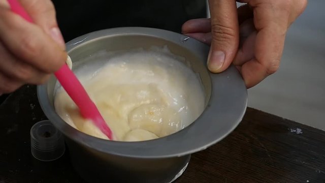 process of mixing of components for reception without an aldehyde paint in a beauty salon. slow motion