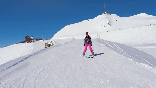 Beginner Skier Woman Carefully And Slowing Skiing Down On Ski Slope In Mountain