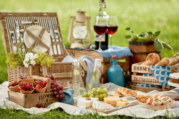 Picnic hamper surrounded by delicious fresh food