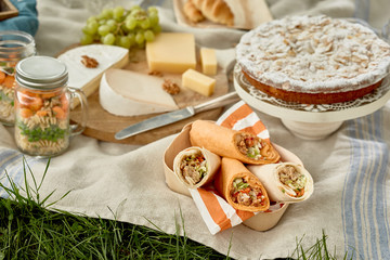 Picnic with kebabs, cake, cheese and pickles