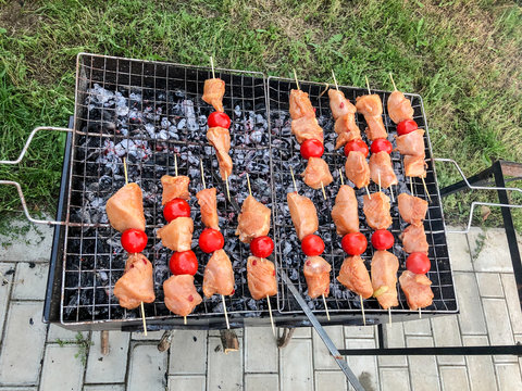 Barbecue of chicken meat with vegetables on the coals. Chicken skewers with grilled vegetables 