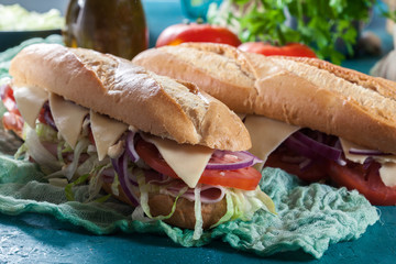 Submarine sandwiches with ham, cheese and vegetables