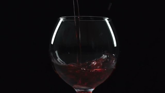 Sommelier slowly pouring red wine in glass, beverage tasting, expensive drink
