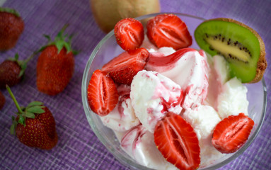 dessert of cream with strawberries and kiwi