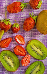 KIVI and strawberry on a lilac background