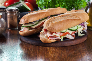 Submarine sandwiches with ham, cheese and vegetables