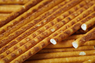 Closeup of salted pretzel sticks scattered around the table