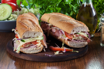 Submarine sandwiches with ham, cheese and vegetables