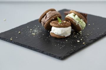 Homemade sandwiches with vanilla, pistachio and chocolate ice cream.