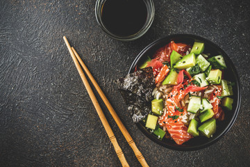 Asian trendy food, sushi poke bowl with cucumber, salmon, avocado, Black and White Sesame Seeds