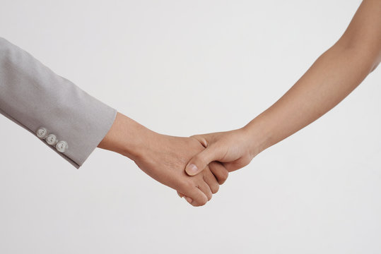 Close-up of female hands shaking hands isolated on white background