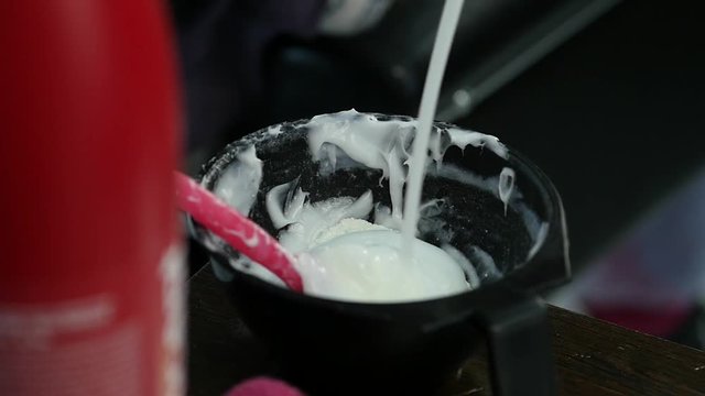 process of mixing of components for reception without an aldehyde paint in a beauty salon. slow motion