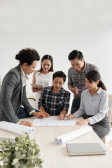 Business team sitting at the table and working on project