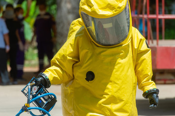 Fireman and hazard protection suit or bright yellow hazmat (hazardous material) suits