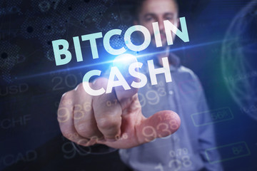 Naklejka na ściany i meble The concept of business, technology, the Internet and the network. A young entrepreneur working on a virtual screen of the future and sees the inscription: bitcoin cash