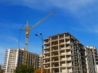 Crane near building.  Building under construction. Construction site.