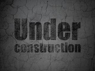 Web design concept: Black Under Construction on grunge textured concrete wall background