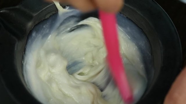 process of mixing of components for reception without an aldehyde paint in a beauty salon. slow motion
