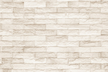 Cream and white brick wall texture background. Brickwork or stonework flooring interior rock old pattern clean concrete grid uneven bricks design stack.