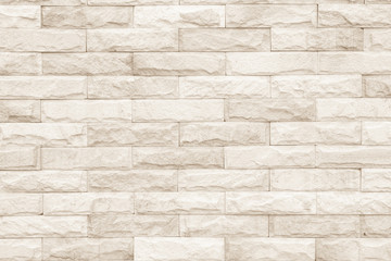 Cream and white brick wall texture background. Brickwork or stonework flooring interior rock old...