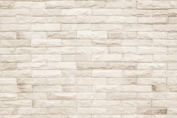 Cream and white brick wall texture background. Brickwork or stonework flooring interior rock old pattern clean concrete grid uneven bricks design stack.