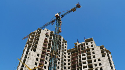 Fototapeta na wymiar Crane. Construction crane. Building crane on the background of the building.