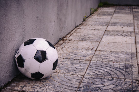 Classic Soccer Ball Near The Gray Wall