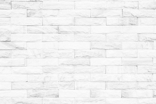 Fototapeta Cream and white brick wall texture background. Brickwork or stonework flooring interior rock old pattern clean concrete grid uneven bricks design stack.