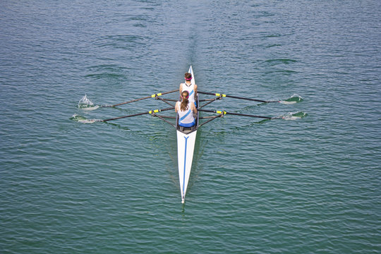 Two young women rowing race in lake