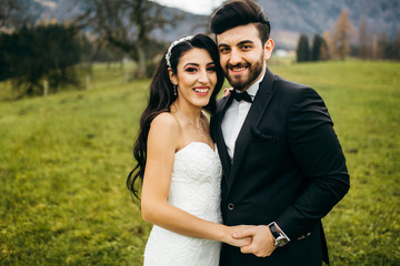 Wonderful bride and groom on the green field