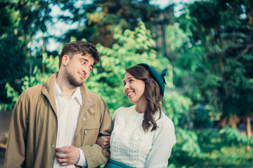 Happy young couple in nature, holding hands together.