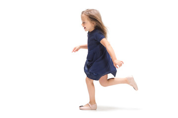 Smiling cute toddler girl three years running over white background