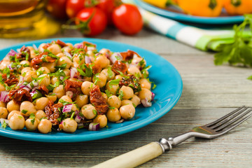 Chickpeas salad with onion and dried tomatoes.