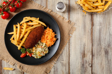 Chicken Kiev (de Volaille chop) with french fries and salads.