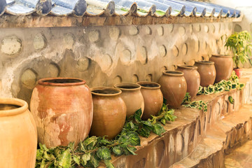 old clay pots standing in a row. Big jars with water