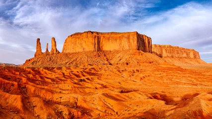 Wall murals orange glow Monument valley landscape view with rock formations and textured foreground