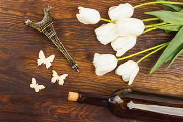 Tulips, bottle of wine and miniaturized Eiffel tower