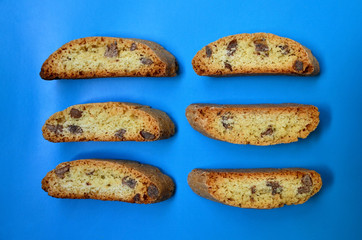 Traditional italian cantuccini almond cookies on a blue background.Delicious homemade cantucci biscotti.Flat lay.Selective focus.