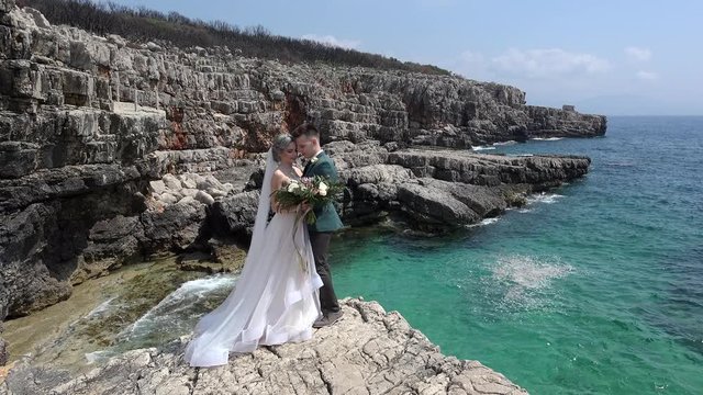 Newlyweds at coastal rocks. Adriatic Sea, Montenegro.