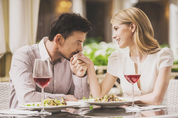 Couple Dating in Restaurant and Drinking Red Wine.