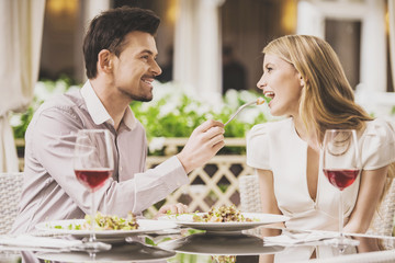 Couple Dating in Restaurant and Drinking Red Wine.
