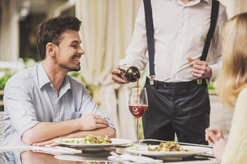 Couple Dating in Restaurant and Drinking Red Wine.