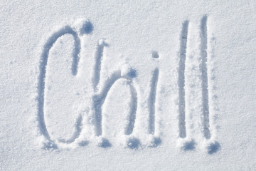 Chill. Hand drawn text over white snow