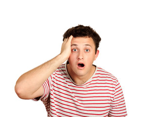man with strong expression of fear, round eyes, open mouth and hands pressed to top of head,...