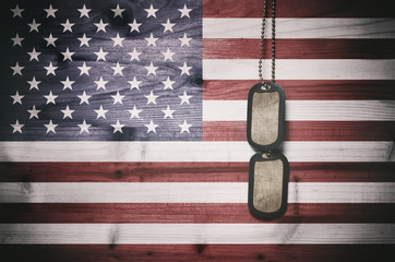 Military dog tags on American flag background